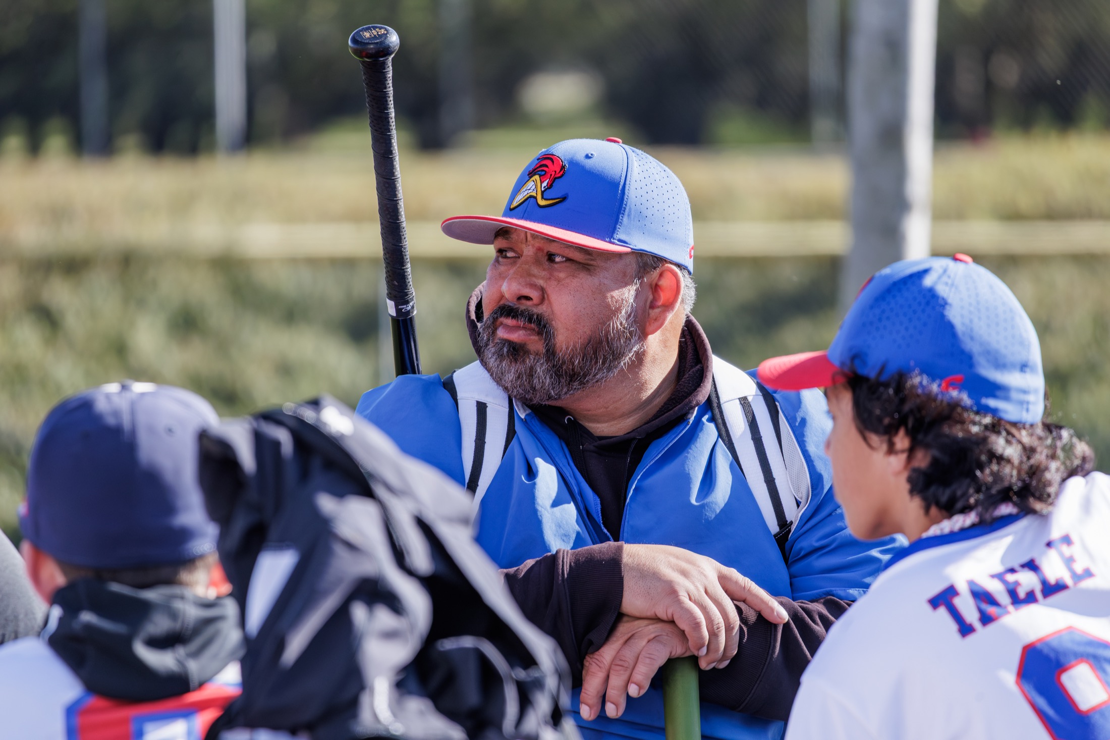 Road Runners coach talking with players in the dugout