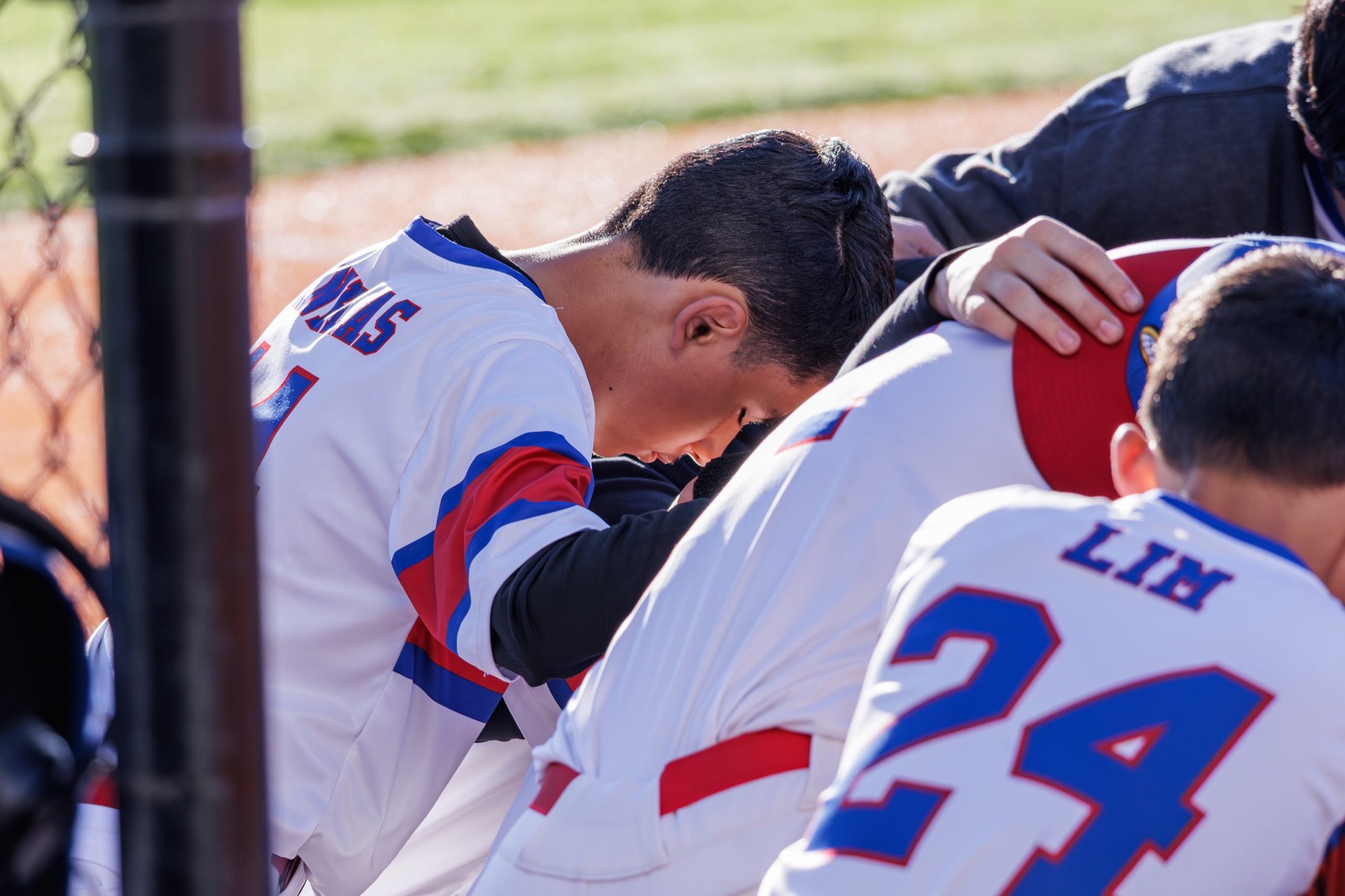 Road Runners players gathered together in the dugout
