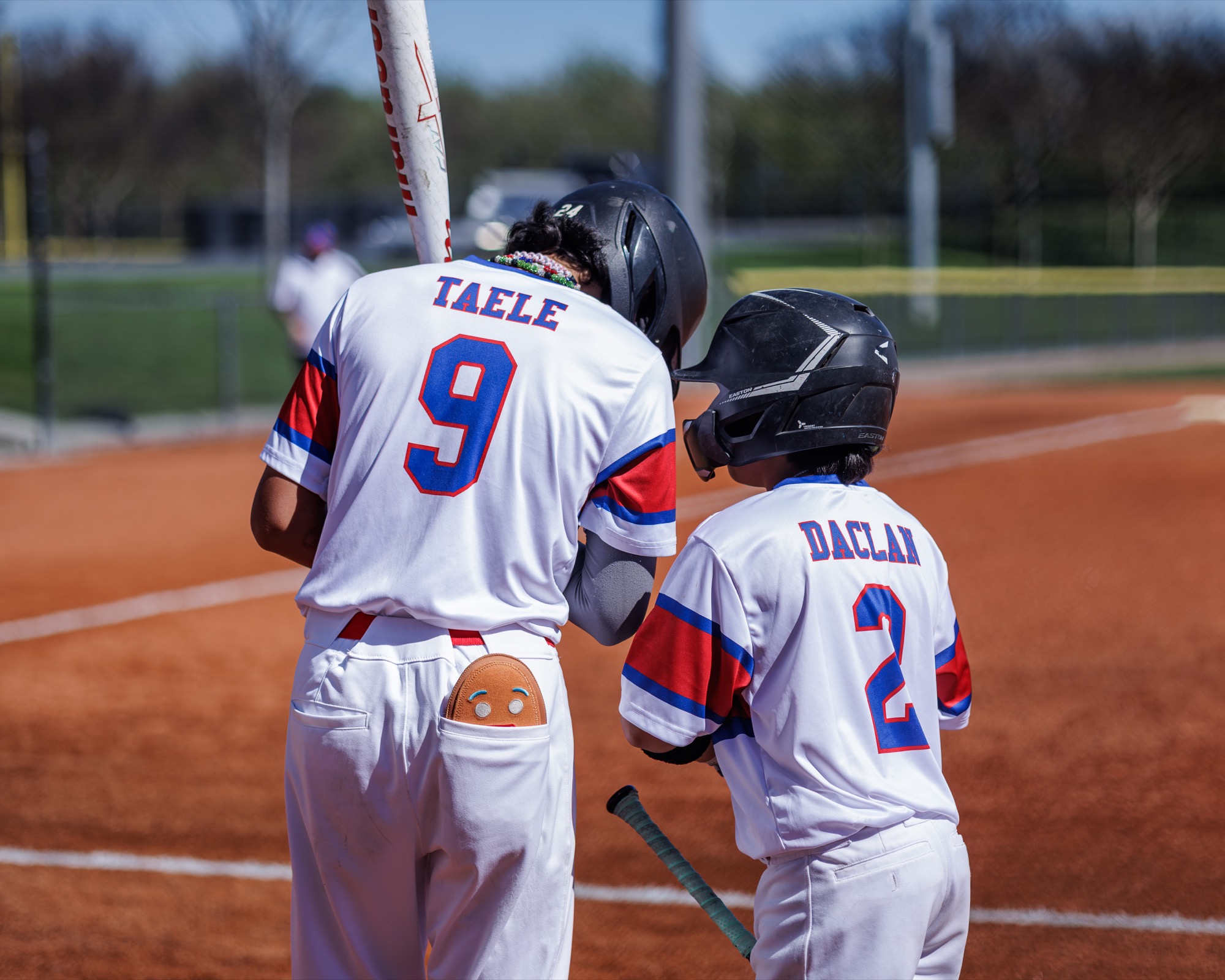 Road Runners teammates preparing near the on-deck circle